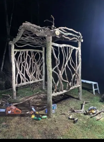 A dense lattice of gnarled black locust branch work in a finished garden structure